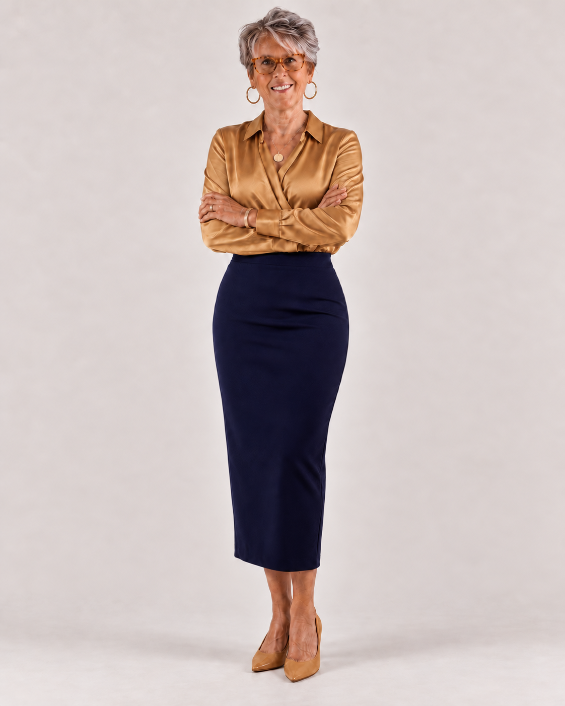 Dr. Nilda Perez standing in a gold blouse and navy skirt